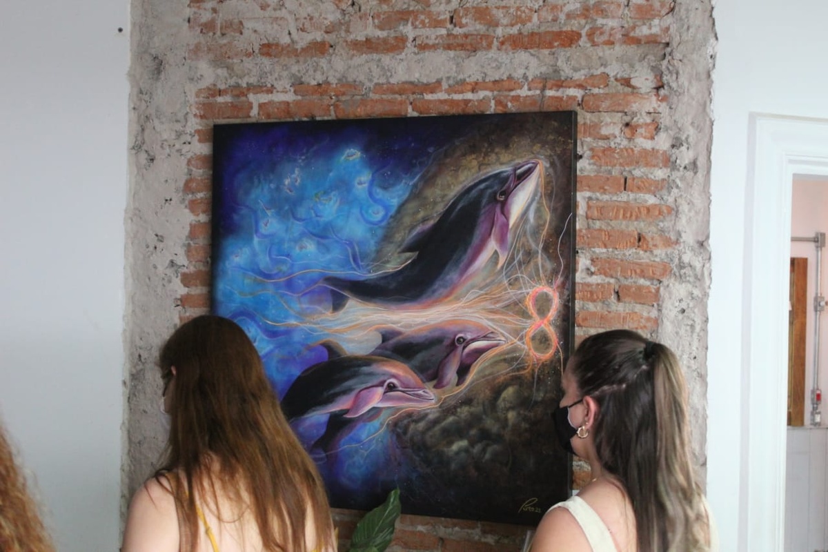 Guests viewing a painting at the 2021 exhibition